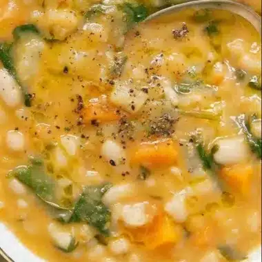 Delicious bowl of flavor-packed white bean soup garnished with fresh herbs