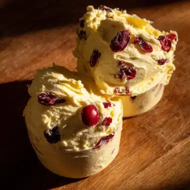 Cranberry-Orange Honey Compound Butter spread on fresh bread.