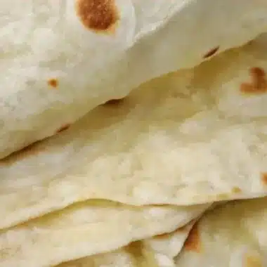 Freshly made sourdough tortillas served on a wooden board