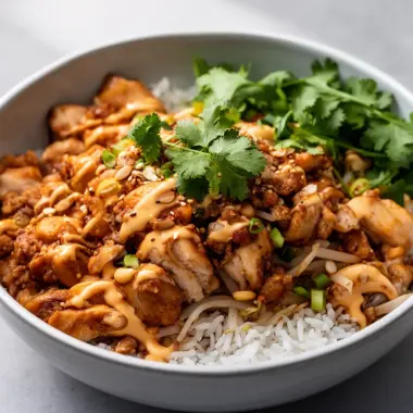 Delectable Bang Bang Chicken Bowl with vibrant vegetables and spicy sauce.